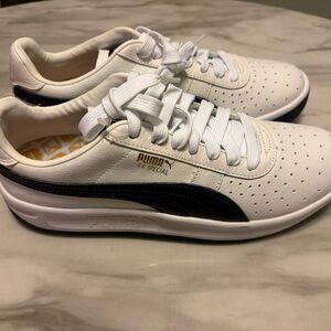Puma White and Black Low-Top Sneakers with Gold Logo